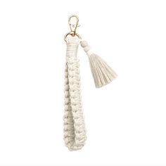 a white keychain with a tassel hanging from it's end and a gold metal hook