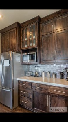 a kitchen with wooden cabinets and stainless steel appliances