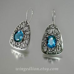 GERTRUDE silver earrings with London Blue Topaz by WingedLion Ornate Sterling Silver Gemstone Earrings, Ornate Gemstone Earrings In Sterling Silver, Silver Topaz Teardrop Earrings, Silver Teardrop Topaz Earrings, Luxury Sterling Silver Filigree Earrings, Ornate Oval Sterling Silver Earrings, Blue Sterling Silver Earrings With Intricate Design, Sterling Silver Blue Earrings With Intricate Design, Ornate Engraved Sterling Silver Earrings