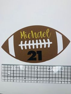 a football with the number 21 on it next to a ruler