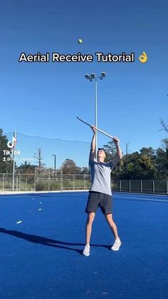 a person on a court with a tennis racket and ball in the air above his head