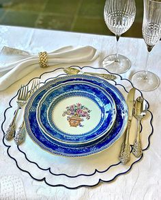 a blue and white place setting with silverware