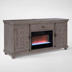 an entertainment center with a fireplace in the middle and flames coming out from its sides