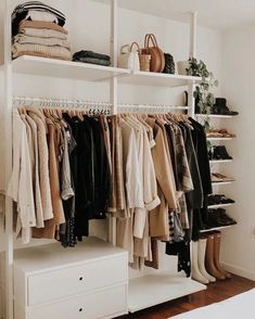 an organized closet with clothes and shoes