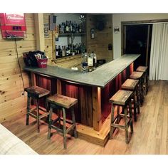 a bar with four stools in front of it