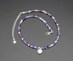 This pretty, beaded moon face charm necklace features, a random mix of glass beads in shades of purple. The beads are a perfect complement to the small Czech glass full moon charm. The whitish, translucent moon has a subtle, molded face which are revealed with flashes of the AB finish. The necklace is adjustable and has a silver plated lobster clasp and extender chain. Makes a cute boho teen gift! Chain length: 14", adjustable to 16.5" Charm is 7/16" long x 7/16" wide I can make this necklace sm Beaded Moon, Celestial Theme, Moon Face, Necklace Purple, Moon Charm, Purple Glass, Shades Of Purple, Boho Necklace, Gifts For Teens