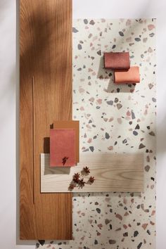 the bathroom is decorated with pink and brown accessories, including toilet paper and wood planks