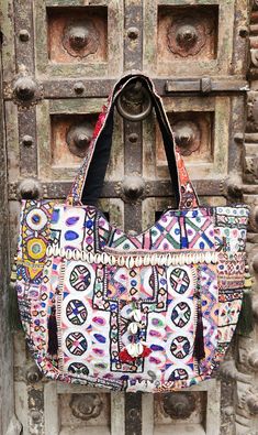 About bag  Indo-gypsy fusion, everyday use hand bag made from Banjara fabrics sourced from Vintage tribal costumes of regions of Rajastan and Gujarat. These are embellished with light catching coins, and intricate bead work tassels. Company details:  Company name: Houseoftextile  Contact number: +919784447473  Email id: houseoftextile77@gmail.com  Shipping & custom : Delivery through one of the finest service providers : Skyway, Fedex, UPS  And DHL. Any local taxes\custom has to be paid by clien Festive Multicolor Rectangular Shoulder Bag, Traditional Handmade Multicolor Hobo Bag, Bohemian Shoulder Bag For Festive Occasions, Festive Multicolor Rectangular Bags, Traditional Hobo Bag For Festivals, Multicolor Festive Shoulder Bag For Festival, Multicolor Shoulder Bag For Festive Occasions, Bohemian Handmade Shoulder Bag For Navratri, Multicolor Mirror Work Shoulder Bag For Festival