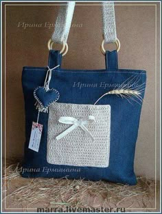 a blue bag with a white bow on it and a tag hanging from the handle