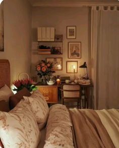 a bedroom with a bed, desk and pictures on the wall