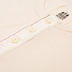 Long-sleeve henley.
Made of 180g/㎡ organic cotton 1x1 rib jersey.
Adjusted fit.
Cotton button tape and red overstitch.
100% "GOTS" certifed organic cotton.
Quality garments made in Portugal. White Cotton T-shirt With Henley Neckline, Cotton Henley T-shirt With Buttons, White Cotton Henley With Buttons, Cotton Henley Neckline T-shirt With Buttons, White Cotton Henley Neckline T-shirt, White Henley Neckline Cotton T-shirt, White Cotton Henley With Henley Neckline, Everyday Cotton Crew Neck Henley, White Crew Neck Henley For Everyday