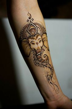 a woman's arm with an elephant tattoo on it