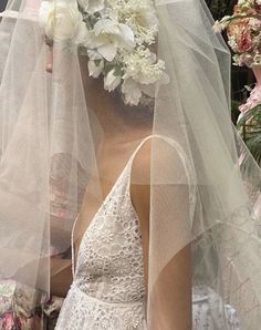 a woman wearing a veil with flowers on her head