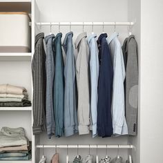 an organized closet with folded shirts and pants