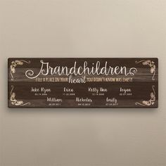 a wooden sign that says grandchilden and features the names of each family member