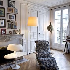 a living room filled with furniture and pictures on the wall