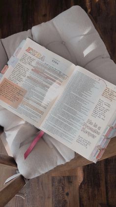 an open book sitting on top of a wooden table