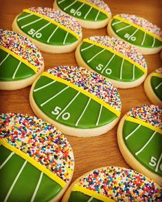 decorated cookies are arranged in the shape of football field