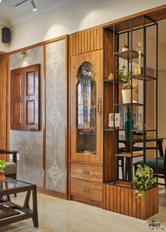 a living room with wood paneling and glass doors on the wall, surrounded by wooden furniture