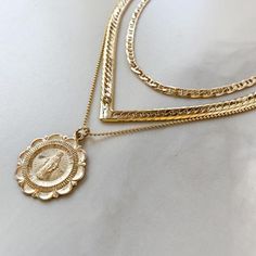 A high quality 14K Gold Filled, double sided, Mary Charm necklace Pendant is 22mm all 14K Gold Filled Choose your length: 16", 18" or 24" 1mm Ball Chain Gold Filled has 100 times more gold than gold plated jewelry. You can swim, shower, etc, this necklace is made to wear exactly like solid 14K Gold and will not chip or fade!Gold filled is created by taking a sheet of 14 karat gold and bonding it through extreme heat and pressure to a core of semi-precious metal (brass). This is a very sophistica Gold Medallion Necklace With Figaro Chain, Gold Medallion With Curb Chain Jewelry, Yellow Gold Medallion Necklace With Curb Chain, Virgin Mary Necklace Gold, Mary Necklace Gold, Sterling Silver Midi Rings, St Christopher Necklace, Mary Necklace, Virgin Mary Necklace