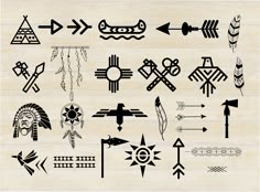 an assortment of native american tattoos on a wooden background, including arrows and other designs