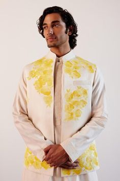 Ivory and yellow sleeveless bundi with bloom hand painted detail. Paired with an ivory kurta and a pant. - Aza Fashions White Fitted Nehru Jacket For Spring, White Nehru Jacket For Spring Formal, Elegant White Bandhgala For Spring, White Bandhgala For Spring Festive Occasion, White Bandhgala For Spring Festivals, Yellow Nehru Jacket For Spring Festivals, Yellow Nehru Jacket For Festive Spring Occasions, White Nehru Jacket For Spring Wedding, Festive Yellow Nehru Jacket For Spring