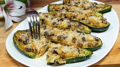 a white plate topped with zucchini covered in cheese