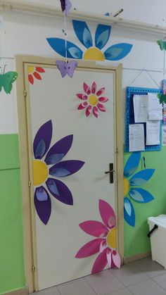 the door is decorated with paper flowers and butterflies on it's sides, along with other decorations