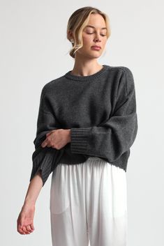 Crafted from luxurious, soft wool, this sweater combines warmth with a modern cropped silhouette. Elegant Wool Sweater For Loungewear, Cashmere Fine Knit Sweater For Loungewear, Fine Knit Cashmere Sweater For Loungewear, Chic Merino Wool Crew Neck Sweater, Fine Knit Fall Loungewear Sweater, Fine Knit Sweater For Fall Loungewear, Fine Knit Loungewear Sweater For Fall, Fall Fine Knit Loungewear Sweater, Chic Fine Knit Cashmere Sweater