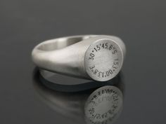 This Signet Ring engraved with personalised coordinates is a timeless symbol of individuality and connection.  At its heart lies the engraving of coordinates that hold profound meaning to you. Whether it's the exact location of your cherished memories -- a childhood home, a favourite vacation spot, or the place where love blossomed -- these coordinates serve as a tangible reminder of the moments and places that shape your journey. The design of the ring is timeless and works to be gender neutral Timeless Jewelry For Anniversary With Hallmarks, Classic Hallmarked Engraved Ring For Commemoration, Classic Engraved Hallmarked Ring For Commemoration, Elegant Rings With Engraving Option For Commemoration, Modern Engraved Round Band Jewelry, Modern Engraved Jewelry With Round Band, Engraved Signet Ring For Commemoration, Elegant Commemoration Rings With Engraving Option, Elegant Commemorative Rings With Engraving Option