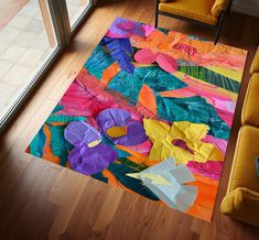 a living room with a couch, chair and rug made out of paper flowers on the floor