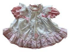 This is a beautiful vintage Pink baby dress with white pinafore sz 3 Mo. Two button  closure on the back. This dress would be perfect for Easter, Church, or a picnic in the park. Anytime you want to show off your beautiful baby would be a time to wear this wonderful item. *email me if you need measurements White Lace Trim Dress For Picnic, Cute White Vintage Dress With Ruffles, White Vintage Dress With Ruffles, Cute White Vintage Dress With Lace Trim, Cute White Cotton Pinafore Dress, White Vintage Dress For Spring Dress-up, Cute White Picnic Dress, Cute White Dress For Picnics, White Vintage Dress For Costume Party