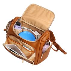 an open brown backpack with items in it