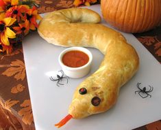 a pastry shaped like a snake and dipping sauce