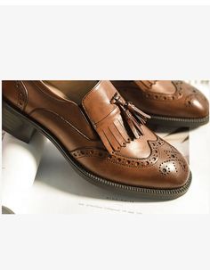 Elegant Tassel Loafers With Brogue Detailing And Cap Toe, Brown Oxfords With Tassels And Round Toe, Brown Wingtip Loafers With Tassels, Elegant Brown Tassel Loafers With Brogue Detailing, Brown Tassel Loafers With Brogue Detailing, Business Tassel Loafers With Brogue Detailing And Round Toe, Fall Wingtip Loafers With Brogue Detailing, Office Wingtip Tassel Loafers With Brogue Detailing, Formal Wingtip Oxfords With Tassels