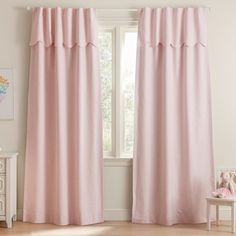 a pink curtain hanging in front of a window