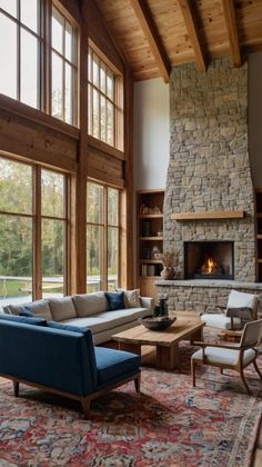 a living room filled with furniture and a fire place in the middle of a room