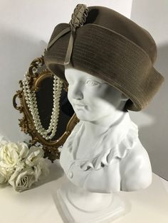 "Vintage 60s Lucila Mendez velvet hat, Vintage1960s Lucila Mendez velvet pillbox hat, Vintage accessories, vintage unique hat, dress hat.  This hat is a neutral taupe color made of velvet with braided ribbon front detail. Height 4.5\" Inside circumference 22\"" Vintage Brown Felt Hat For Formal Occasions, Vintage Brown Formal Hat, Vintage Brimmed Cloche Hat For Winter, Vintage Winter Brimmed Cloche Hat, Winter Vintage Brimmed Cloche Hat, Vintage Cloche Hat For Winter, Vintage Wide Brim Felt Hat For Evening, Vintage Cloche Hat With Short Brim For Parties, Vintage Short Brim Party Hats