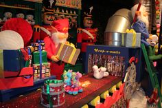 an assortment of toys and other items on display in a toy store with santa claus