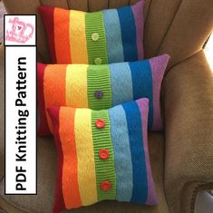 two colorful knitted pillows sitting on top of a chair