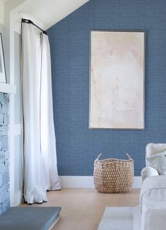 a living room with blue walls and white furniture