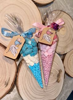 some candy cones are sitting on top of wood slices with tags attached to the them