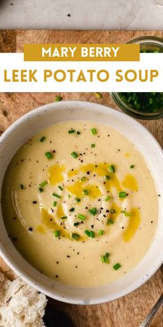 a white bowl filled with soup next to bread