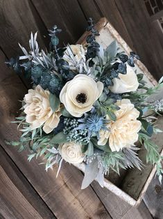 a bouquet of flowers sitting on top of a wooden box