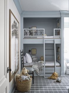 a bedroom with bunk beds and stuffed animals in the corner, along with other furniture