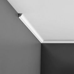 a black and white photo of a room with a ceiling light in the corner,