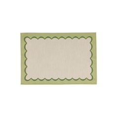 a green and white place mat with scalloped edges