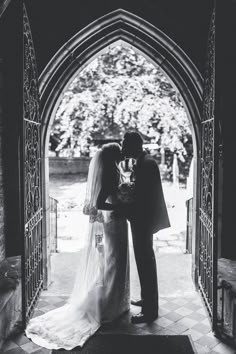 a bride and groom kissing in front of an arched doorway with the words, i do not know what this is