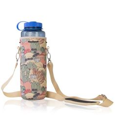 a water bottle with a strap attached to it and an orange flower pattern on the side