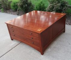 a wooden desk sitting on top of a sidewalk